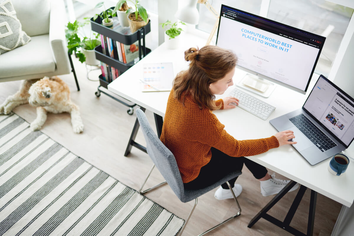 girl sitting at desk on her computer looking at internships at MetroStar