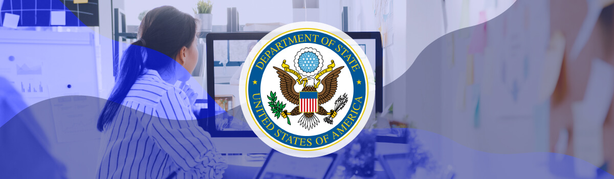 A woman working on a computer with an overlay of the U.S. Department of State seal