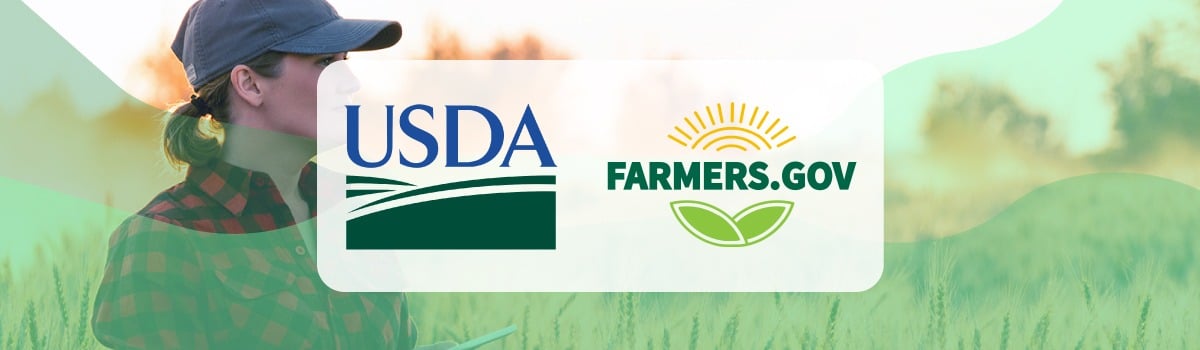 A woman standing in a field with an ipad and an overlay of the USDA logo on top of the image