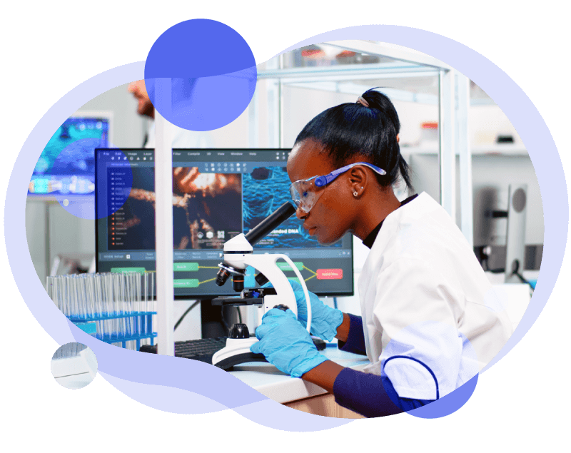 Industry_healthIT Image of a young female scientist looking through a microscope in a lab with a monitor showing data in the background. The image is cropped to a round shape with purple overlay circles