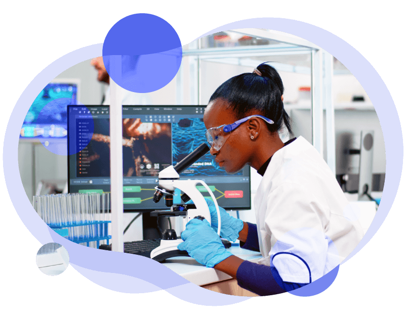 Image of a young female scientist looking through a microscope in a lab with a monitor showing data in the background. The image is cropped to a round shape with purple overlay circles