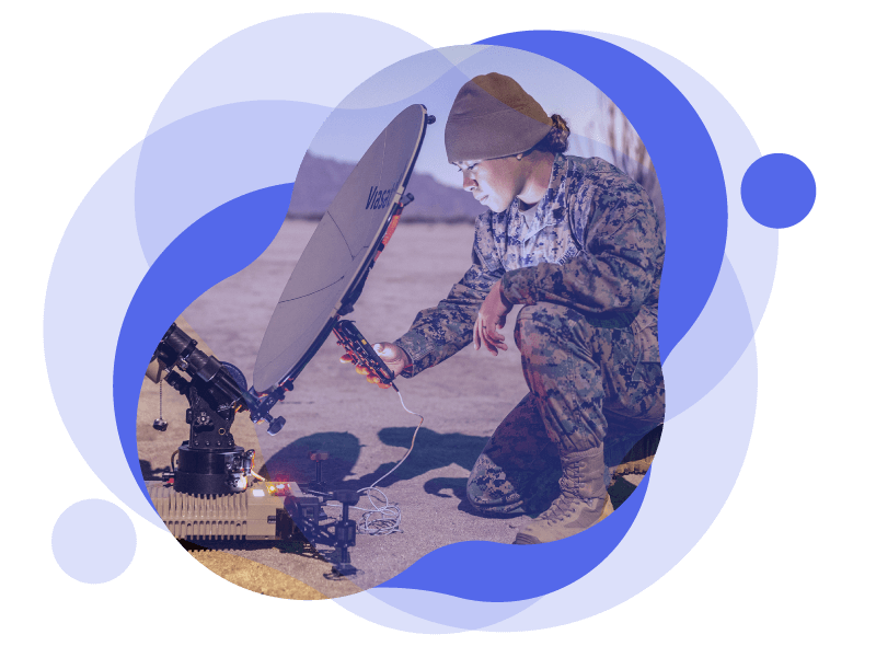 Female USMC soldier working in the field with a remote and satellite