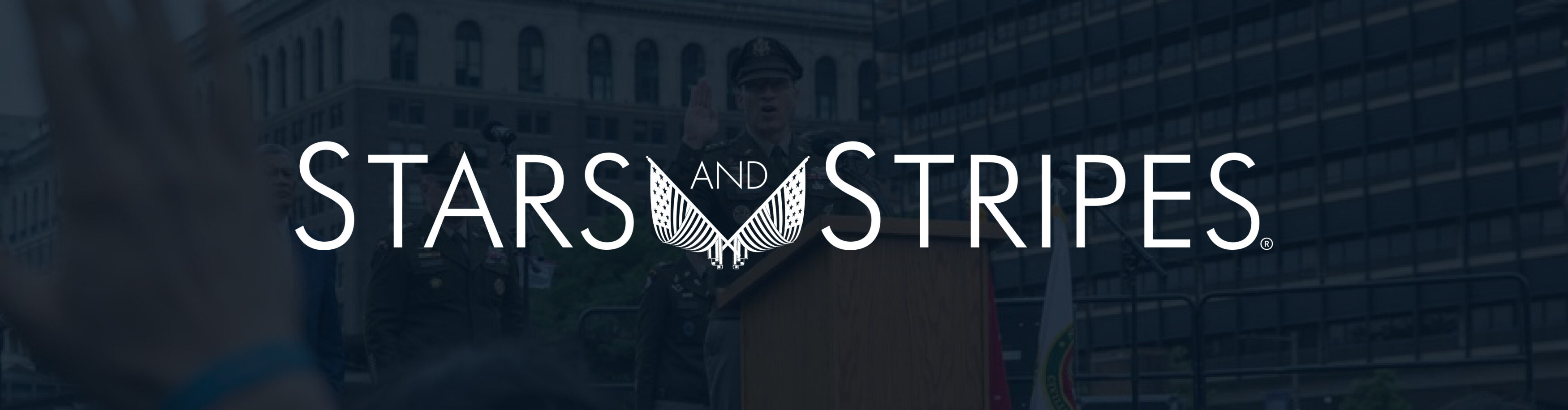 White Stars and Stripes Logo on Darkened background